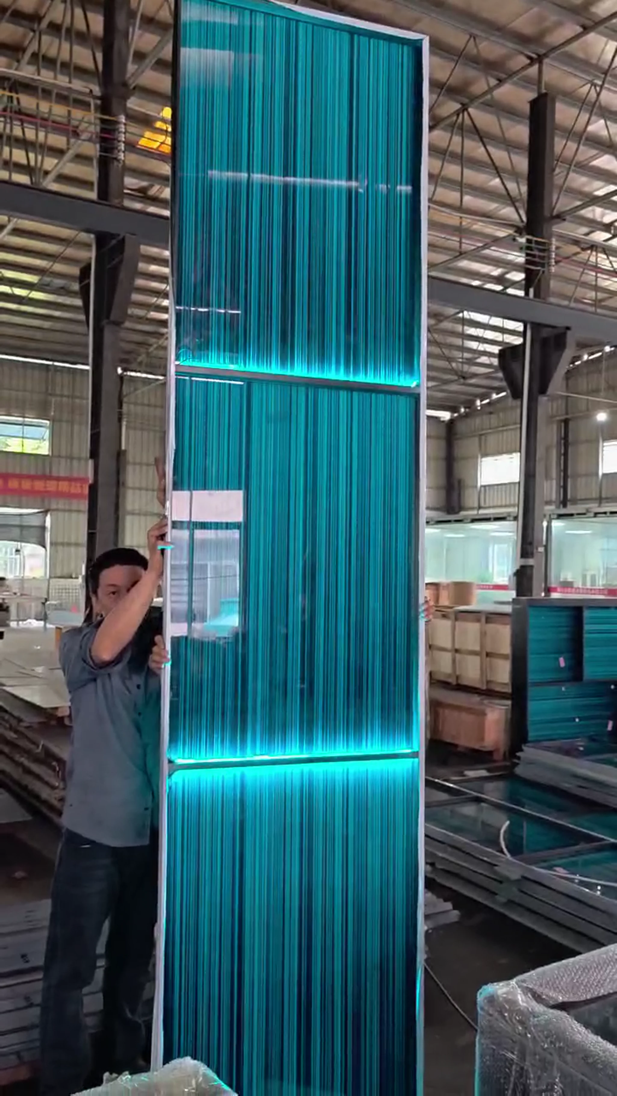 Tall illuminated stainless steel screen panel in the workshop